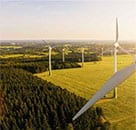 Image of wind turbine power generators in a field representing renewable energy and commodities market operations for risk analytics.