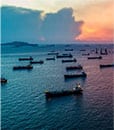 Oil ships on the water at dusk representing Lacima's work in the LNG markets, offering a complete solution for structuring and trading, to risk management of LNG portfolios.