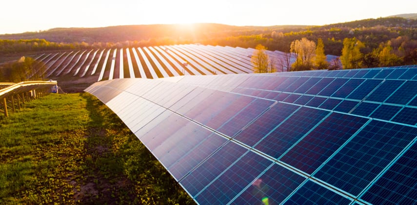Solar farm at sunset representing renewable asset valuation and energy risk modelling