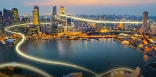 A high-tech cityscape with a bustling harbour, showcasing modern infrastructure and its connection to energy and commodities markets.