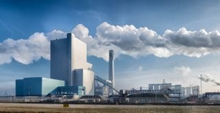 An industrial commodities processing plant with machinery and pipelines, symbolising energy and commodities market operations for risk analytics.