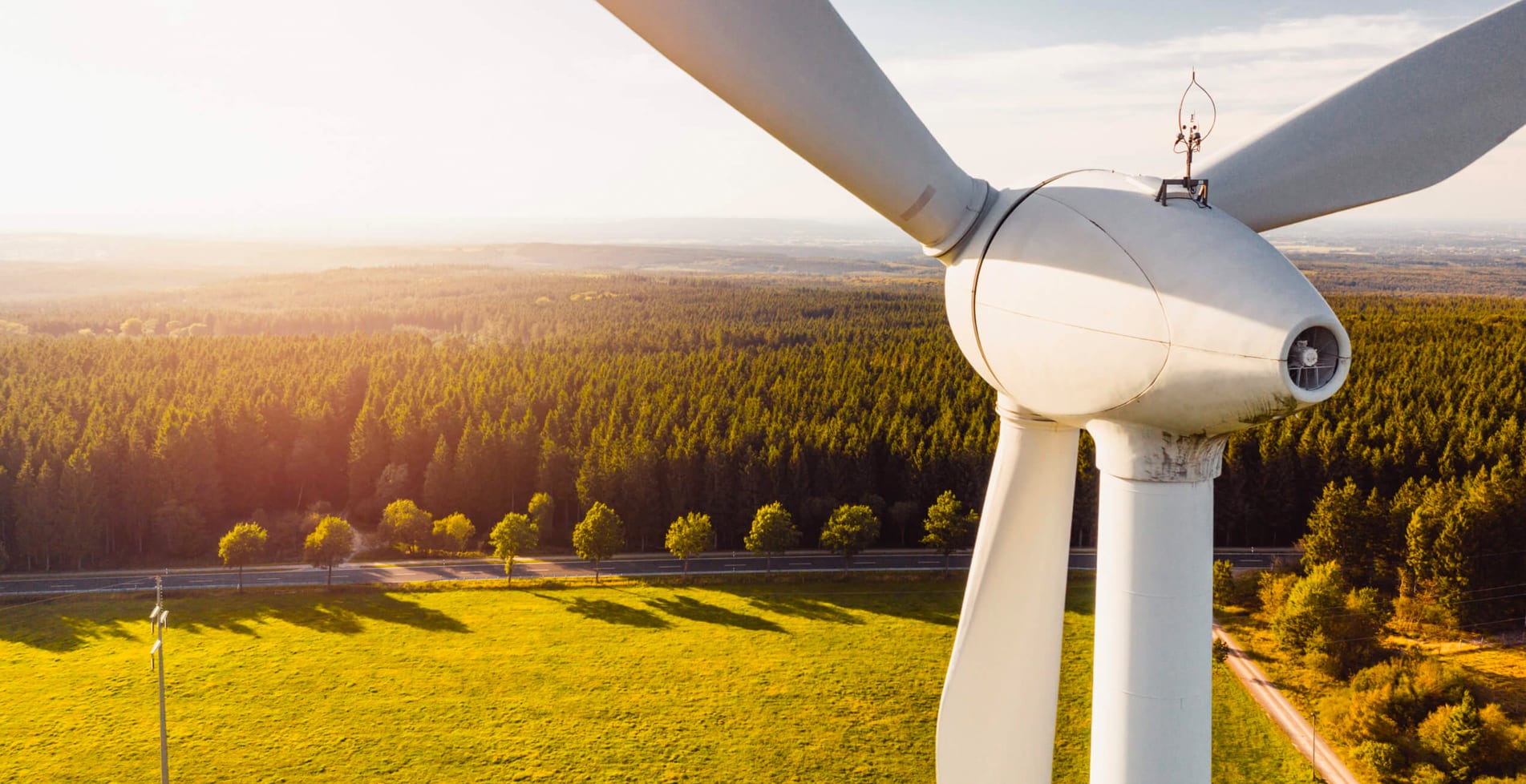 Wind turbine at sunset representing Lacima’s role in advancing risk analytics for the energy transition