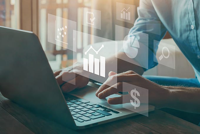 Image of person using laptop to symbolise energy trading, valuation, optimisation, and risk management software.